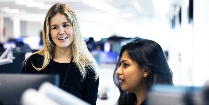 Two colleagues in discussion at the Singapore office.