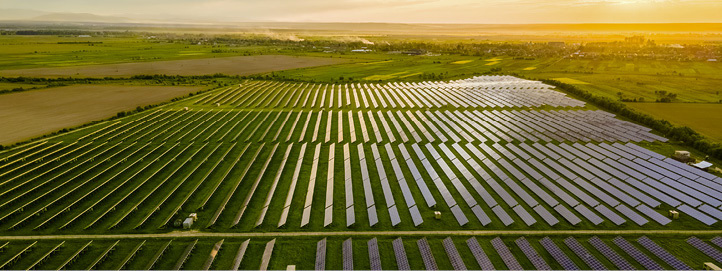 Aerial view of a large solar power plant at sunset.