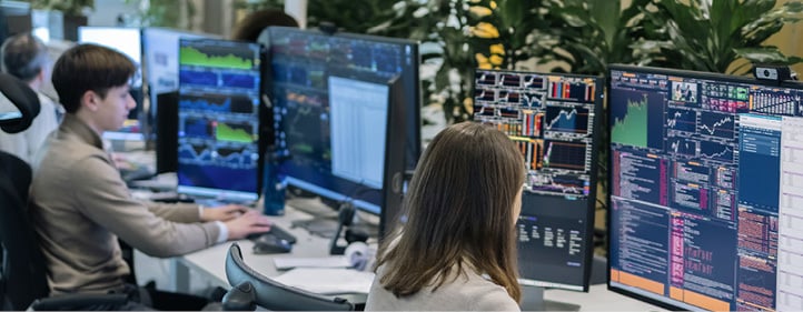 Two people are working at a desk with multiple computer screens.
AI generated content