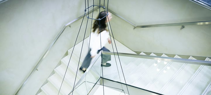 A woman is walking down a staircase in a building.

AI generated content