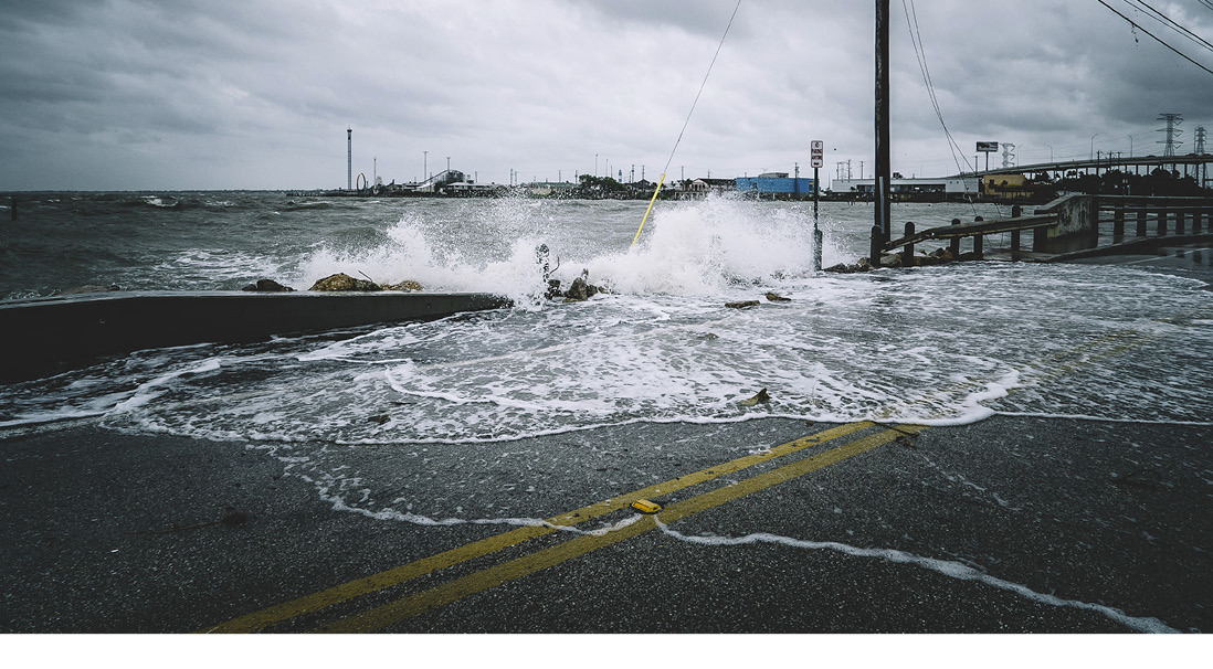 Waves crashing across the road