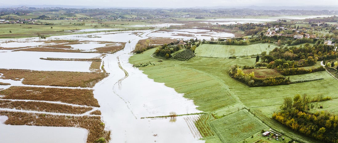 Aerial view of flooded farmland and surrounding countryside.