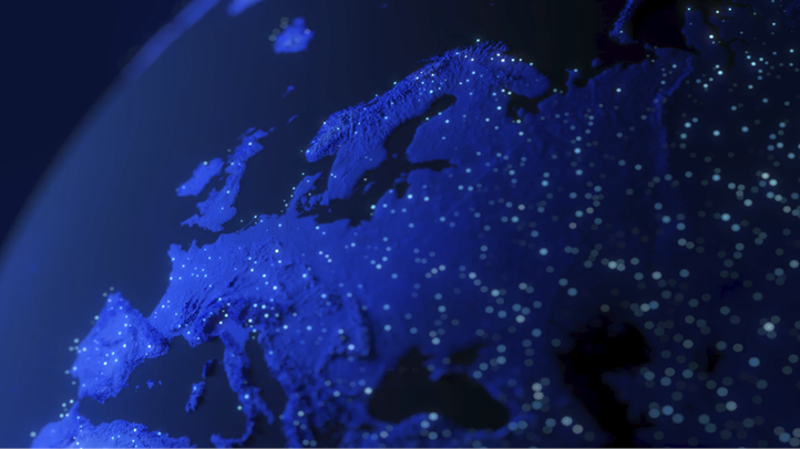 Close-up of a digital map of Europe illuminated with blue light and data points.